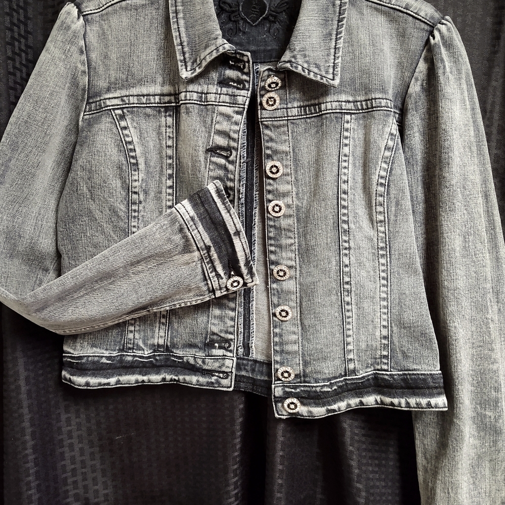 Stonewashed jean jacket with accent buttons.